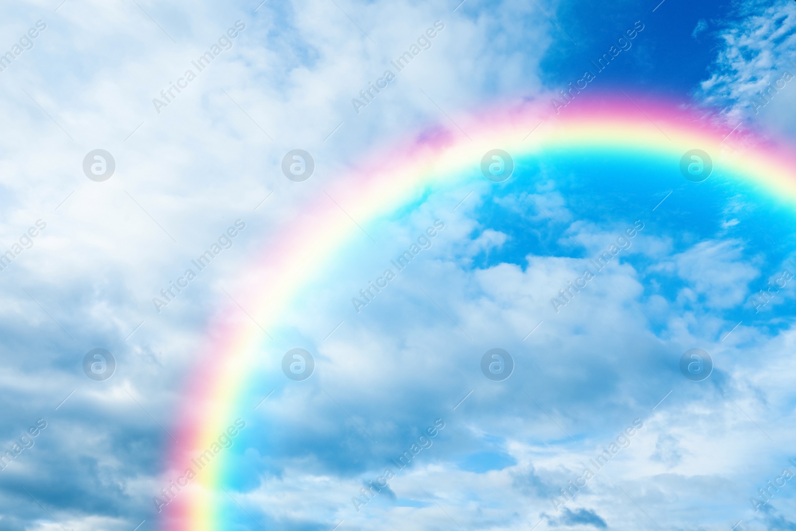 Image of Picturesque view of beautiful rainbow and blue sky on sunny day 