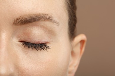 Photo of Woman with long eyelashes after mascara applying, closeup