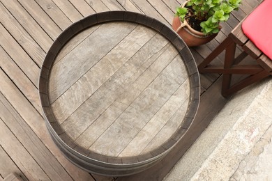 Photo of Traditional wooden barrel outdoors, top view. Wine making