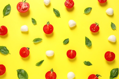 Flat lay composition with fresh ingredients for pizza on yellow background