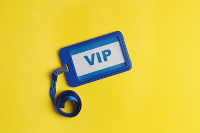 Photo of Vip badge on yellow background, top view