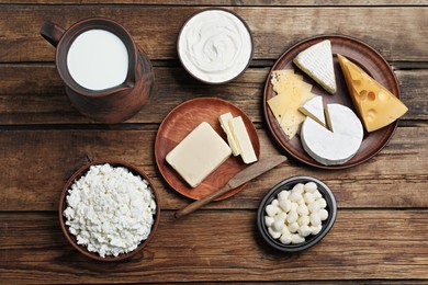 Photo of Flat lay composition with dairy products and clay dishware on wooden table
