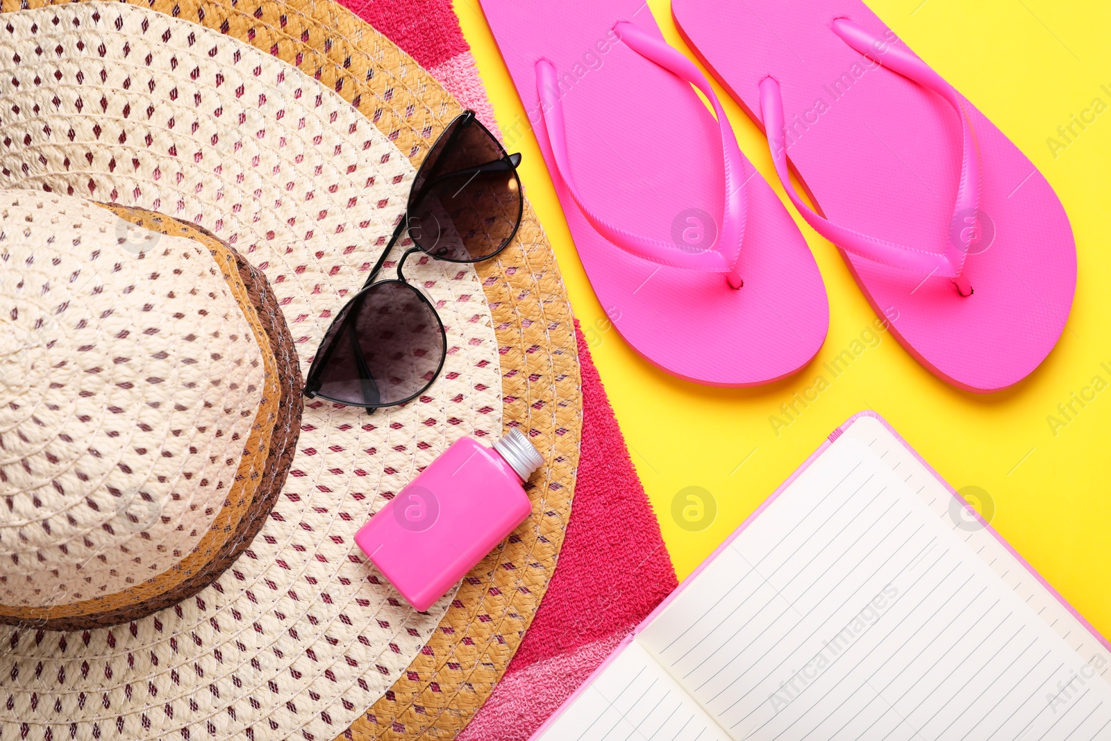 Photo of Flat lay composition with beach accessories on yellow background