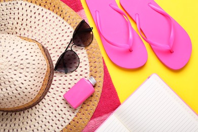 Photo of Flat lay composition with beach accessories on yellow background