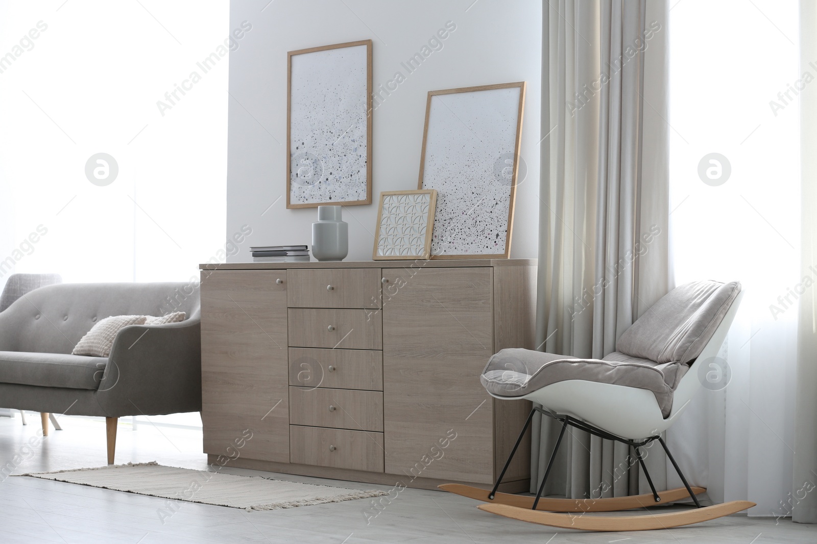 Photo of Modern room interior with stylish chest of drawers