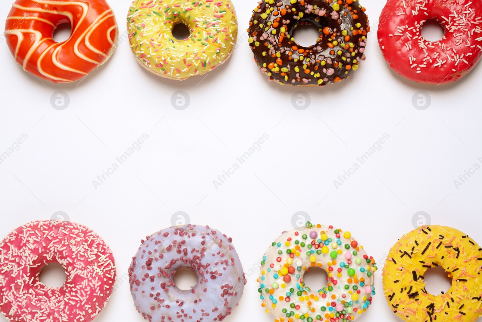 Photo of Delicious glazed donuts on white background, flat lay. Space for text