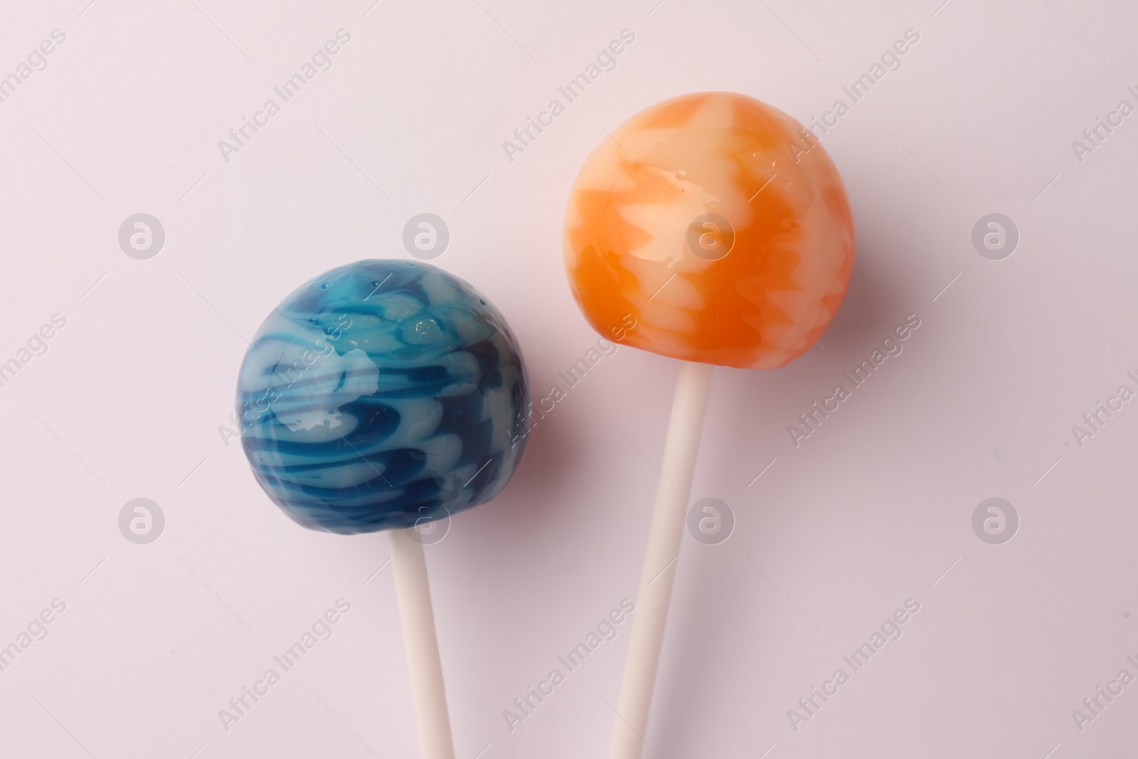 Photo of Tasty lollipops on white background, flat lay