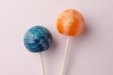 Photo of Tasty lollipops on white background, flat lay