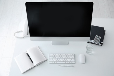 Photo of Stylish workplace with modern computer on desk, top view