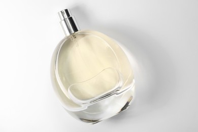 Luxury women's perfume in bottle on white background, top view