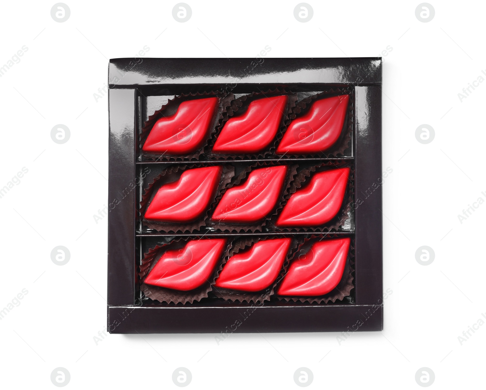 Photo of Box with lip shaped chocolate candies isolated on white, top view