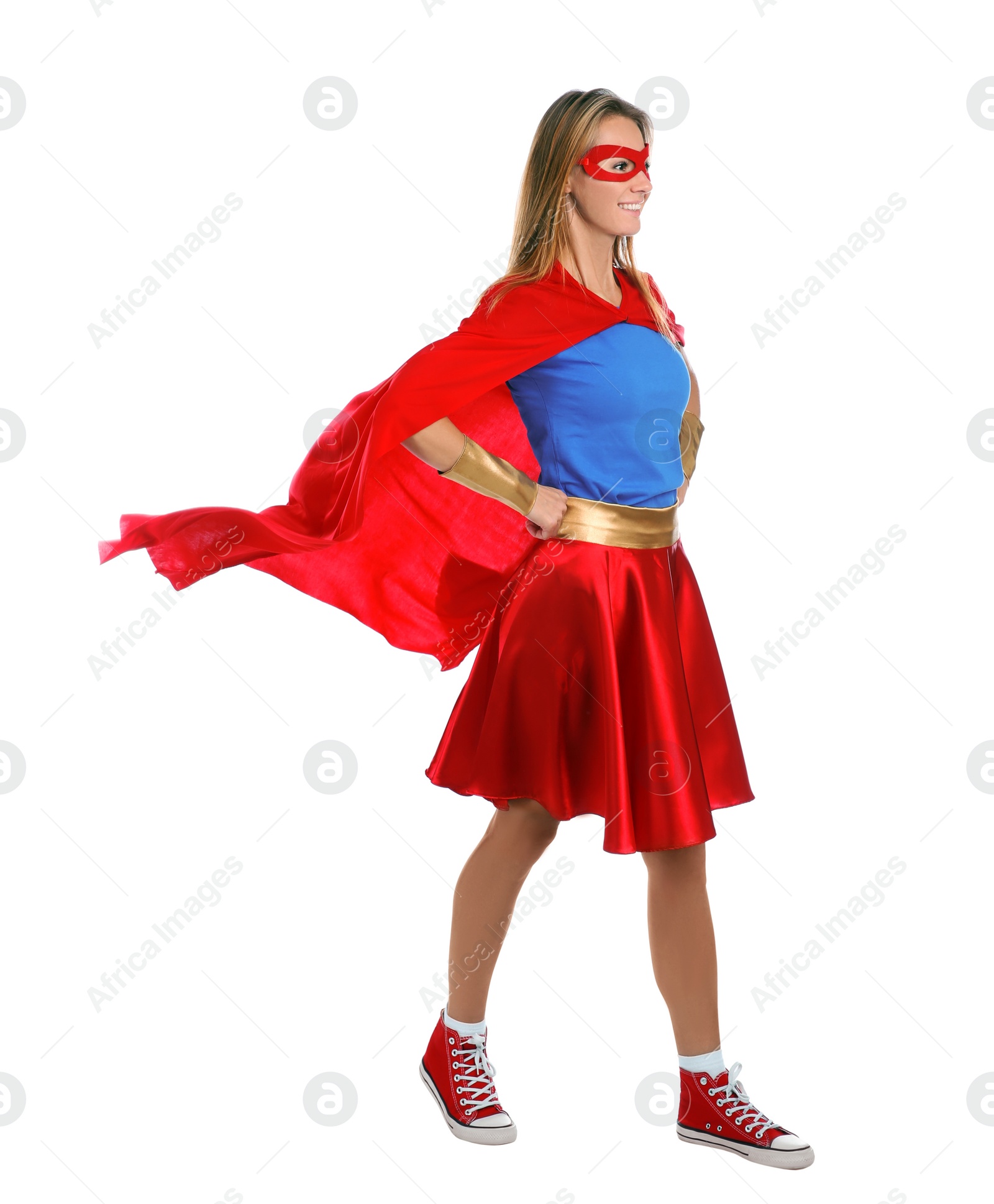Photo of Confident woman wearing superhero costume on white background