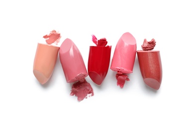 Photo of Different lipstick swatches on white background, top view