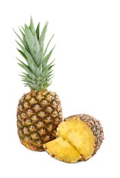 Whole and cut tasty ripe pineapples isolated on white