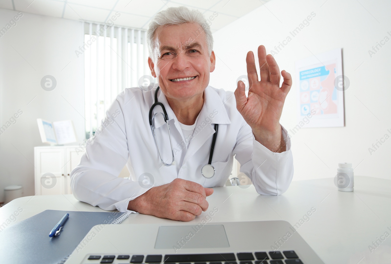 Photo of Doctor consulting patient using video chat in clinic, view from web camera