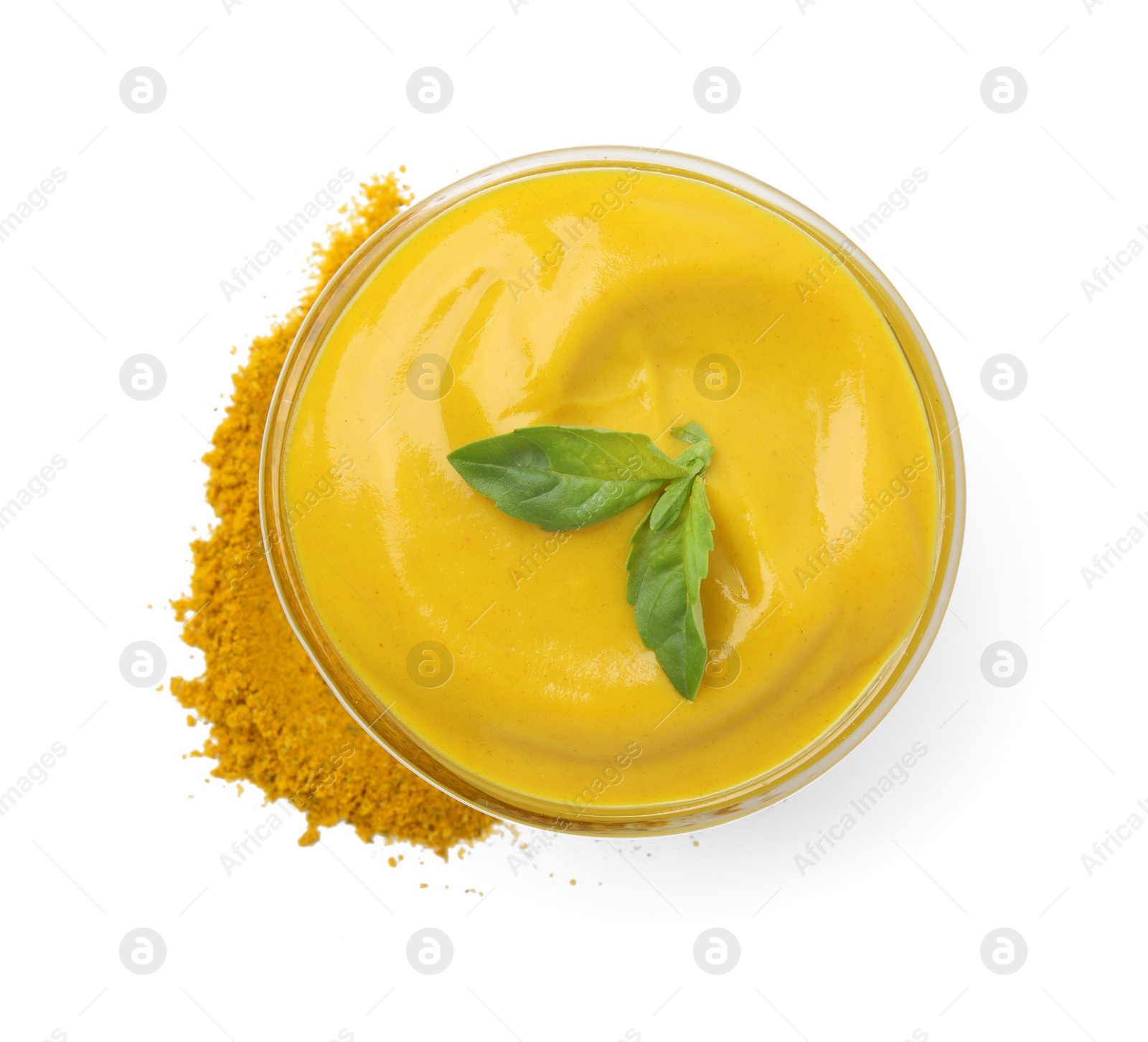 Photo of Bowl with tasty curry sauce, powder and basil isolated on white, top view