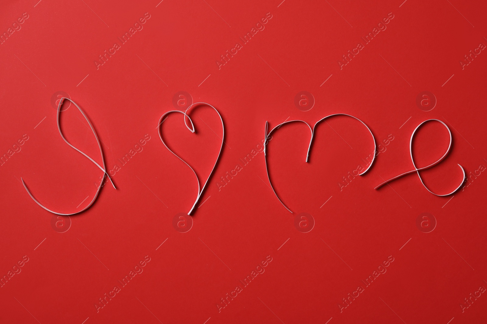 Photo of Phrase I Love Me made with paper strips on red background, flat lay