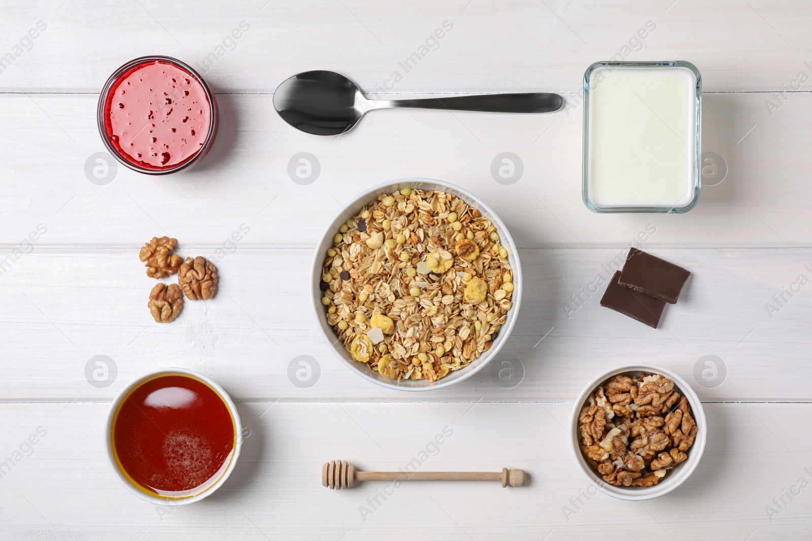 Photo of Flat lay composition with tasty muesli for breakfast on white wooden table