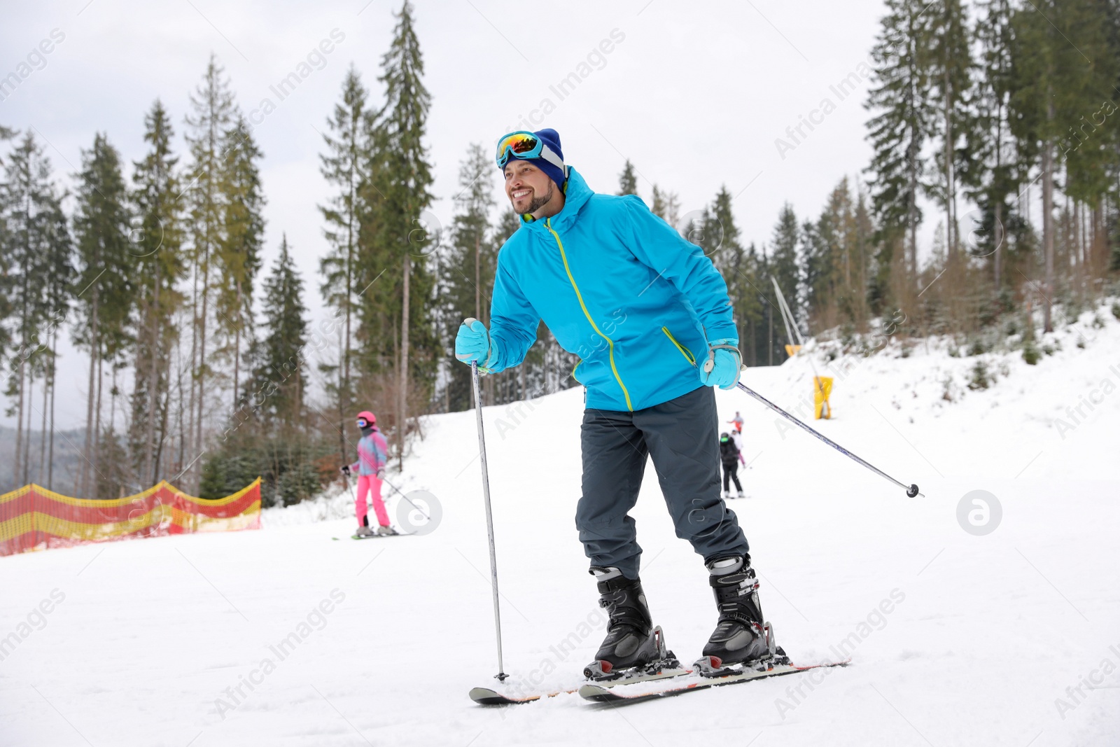 Photo of Male skier on slope at resort. Winter vacation