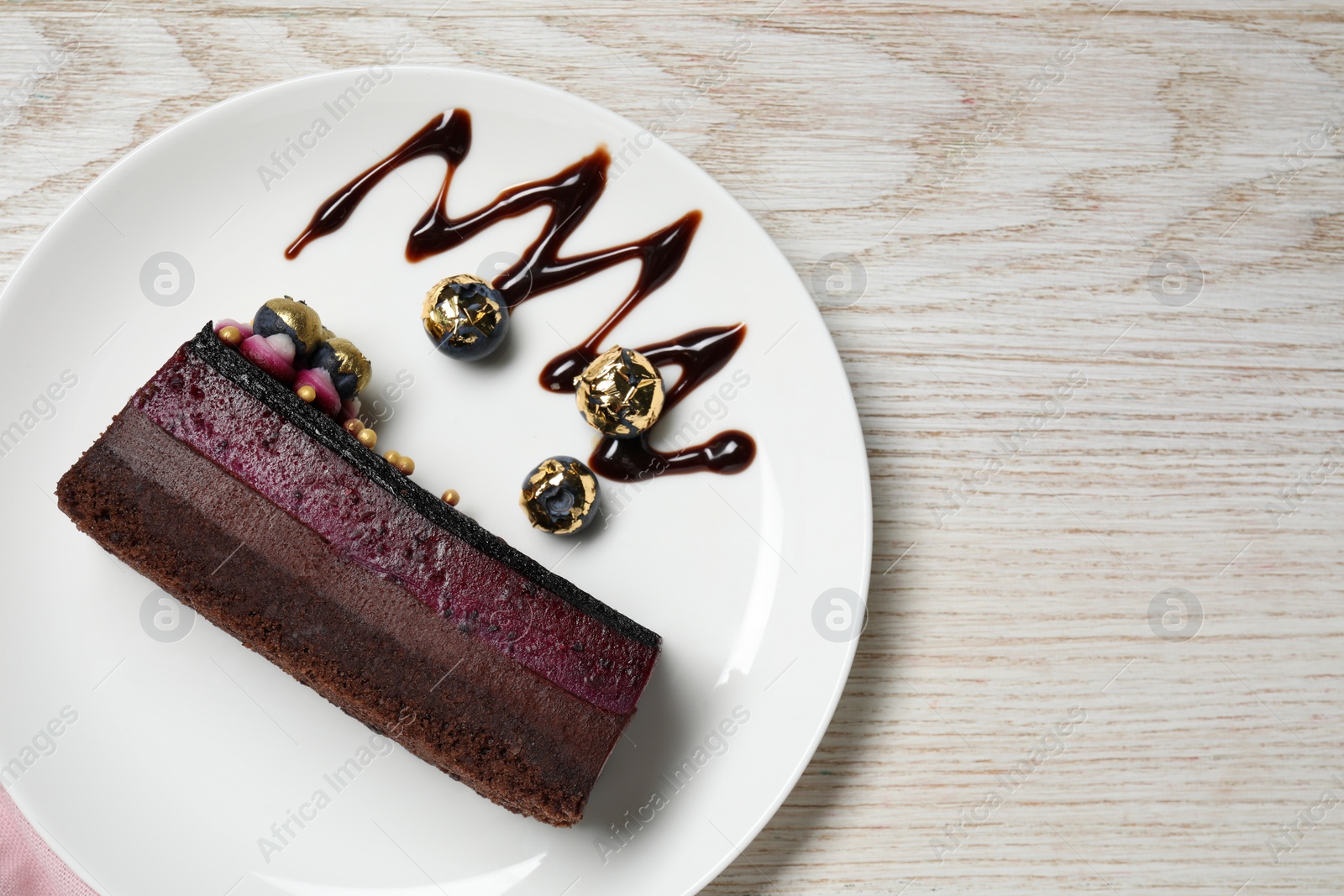 Photo of Delicious cake with blueberry on white wooden table, top view. Space for text