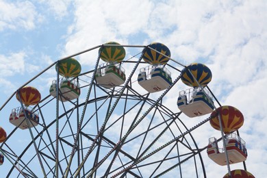 Beautiful observation wheel against blue sky, low angle view