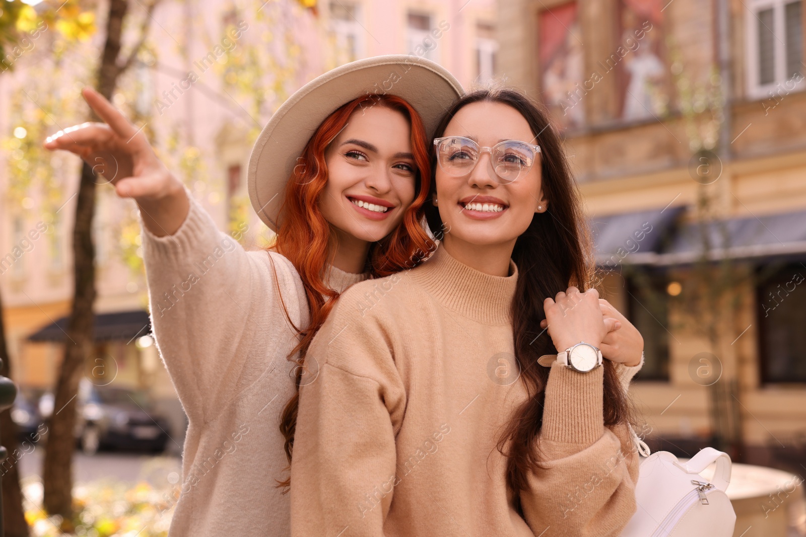 Photo of Happy friends spending time together outdoors on autumn day