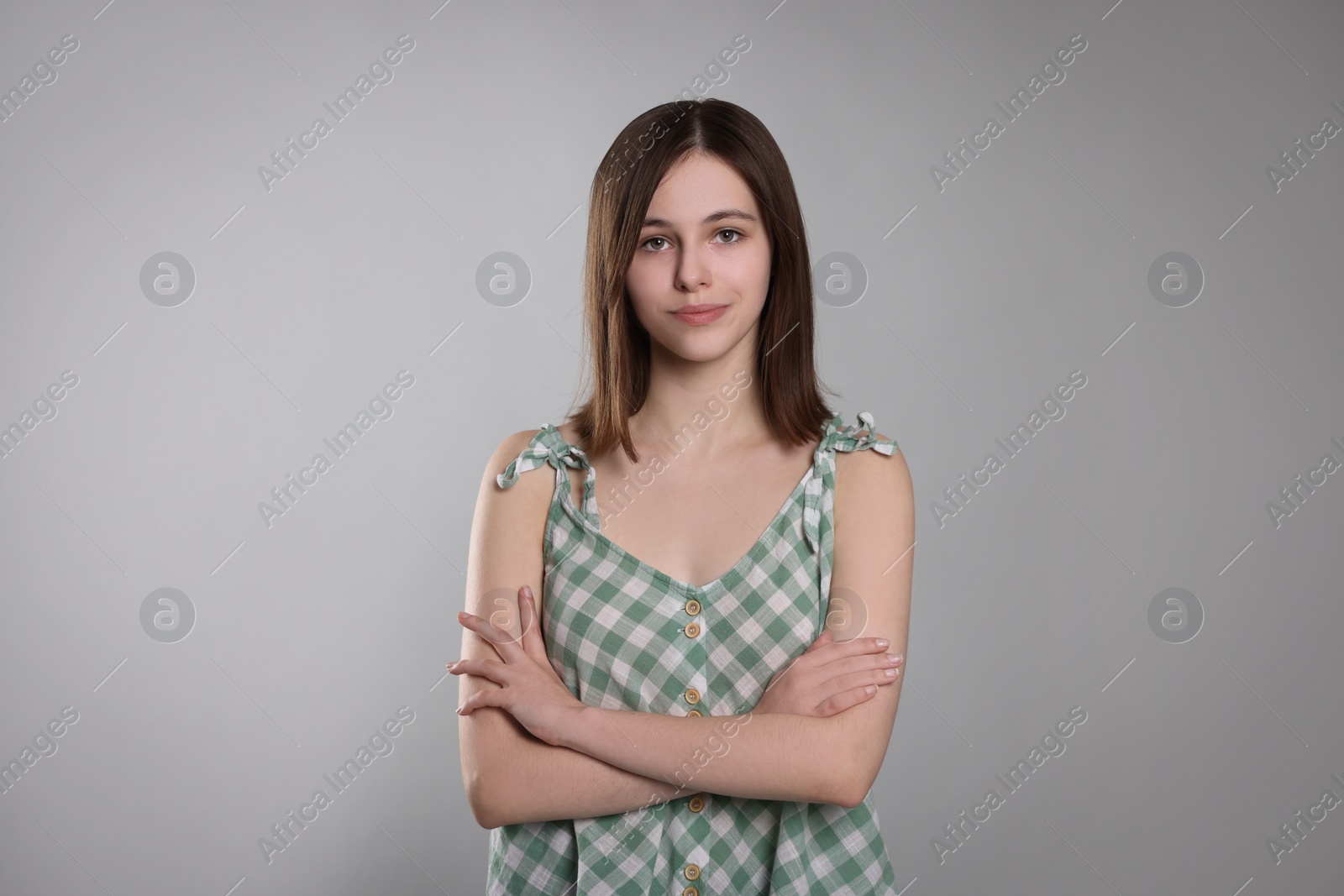 Photo of Portrait of cute teenage girl on light grey background