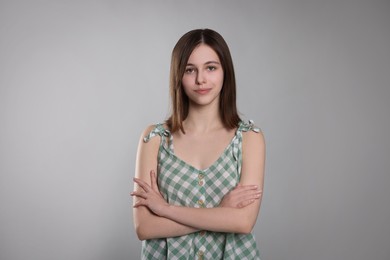 Photo of Portrait of cute teenage girl on light grey background