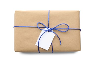 Photo of Parcel wrapped in kraft paper with tag on white background, top view