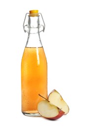 Photo of Glass bottle with delicious cider and pieces of ripe apple on white background