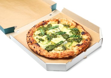 Photo of Delicious pizza with pesto, cheese and arugula in cardboard box on white background