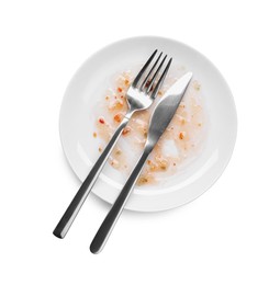 Dirty plate and cutlery on white background, top view