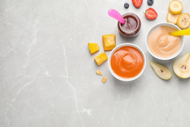 Photo of Healthy baby food and ingredients on grey table, flat lay. Space for text