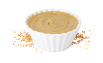 Fresh tasty mustard sauce in bowl and dry seeds isolated on white