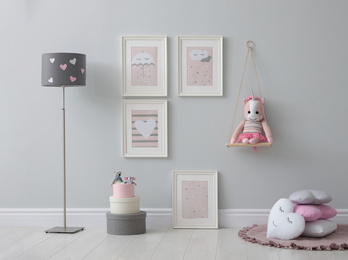 Stylish room interior with beautiful pictures and toys