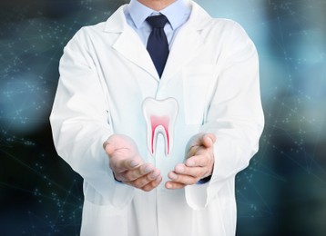 Image of Dentist showing virtual model of tooth on blurred background, closeup