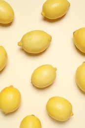 Fresh ripe lemons on beige background, flat lay