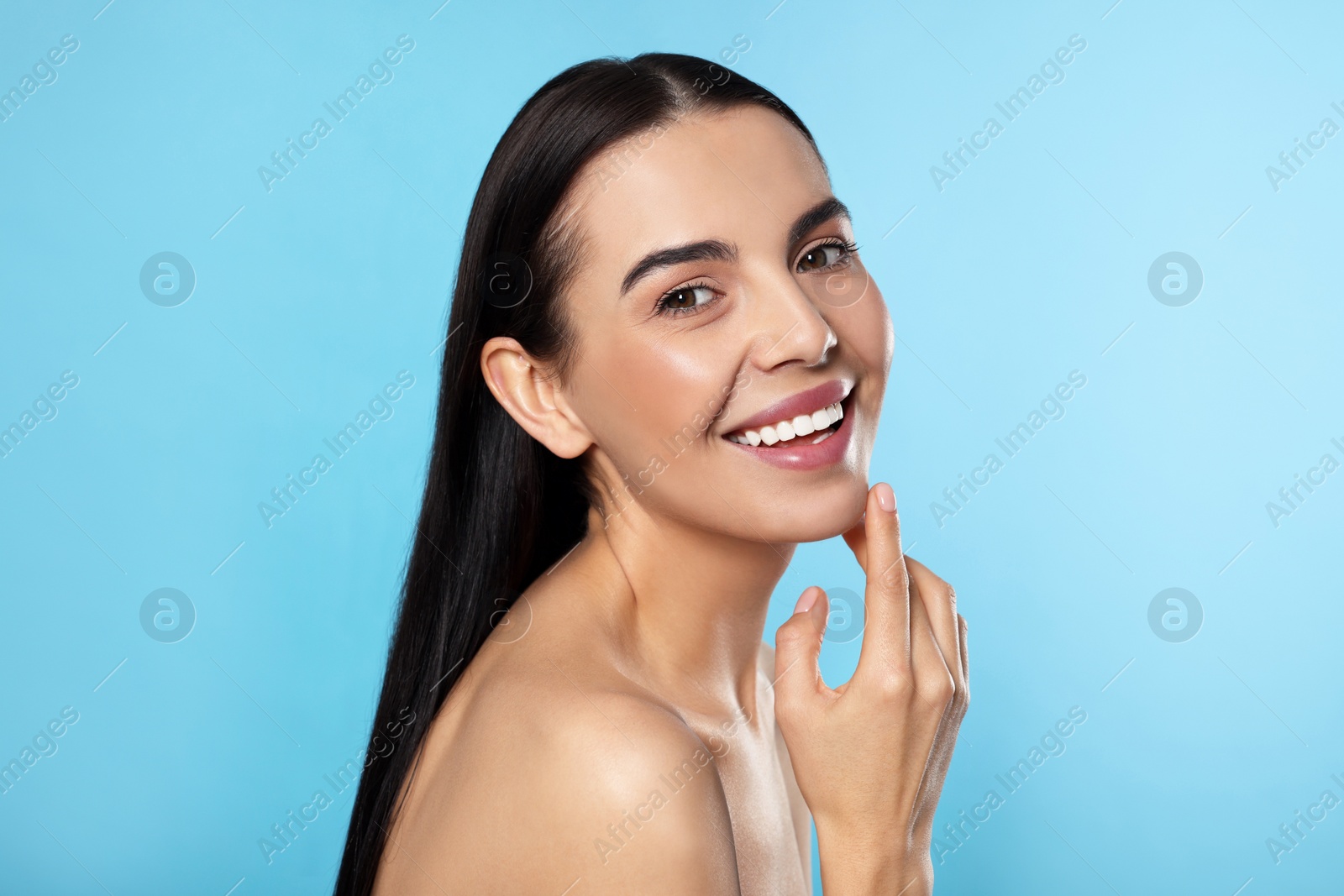 Photo of Portrait of attractive young woman on light blue background. Spa treatment