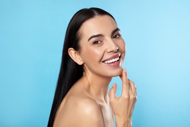 Photo of Portraitattractive young woman on light blue background. Spa treatment