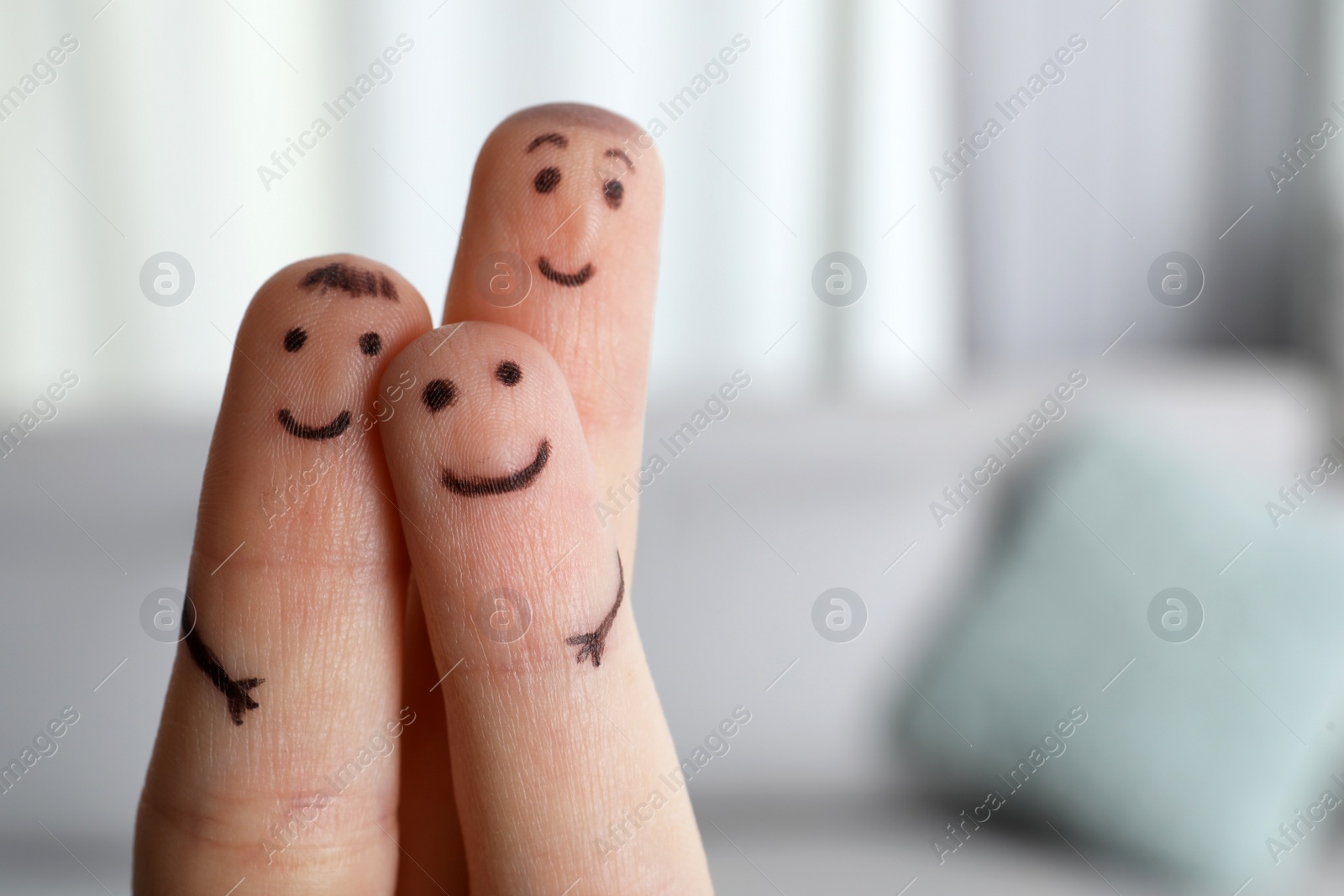 Photo of Three fingers with drawings of happy faces on blurred background, space for text