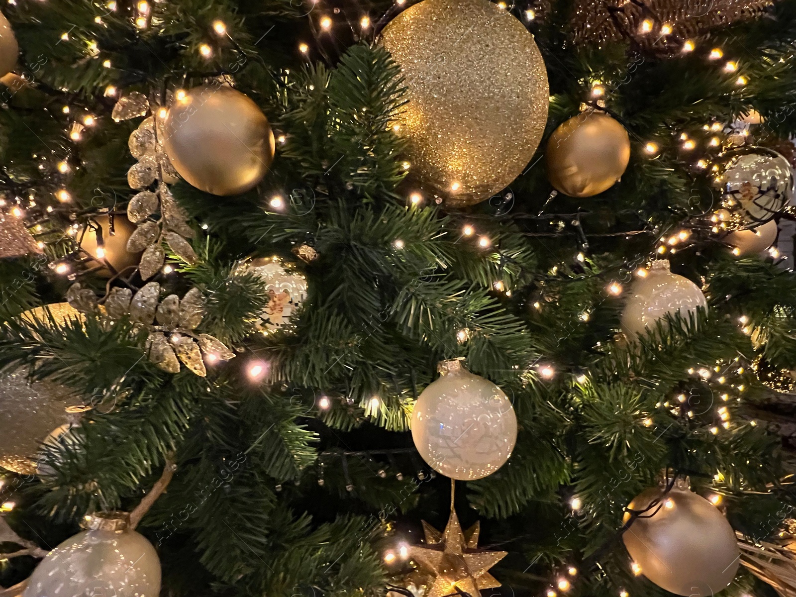 Photo of Beautiful Christmas tree decorated with baubles and festive lights as background, closeup