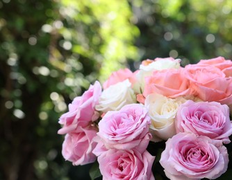 Photo of Beautiful bouquet of aromatic roses outdoors, closeup