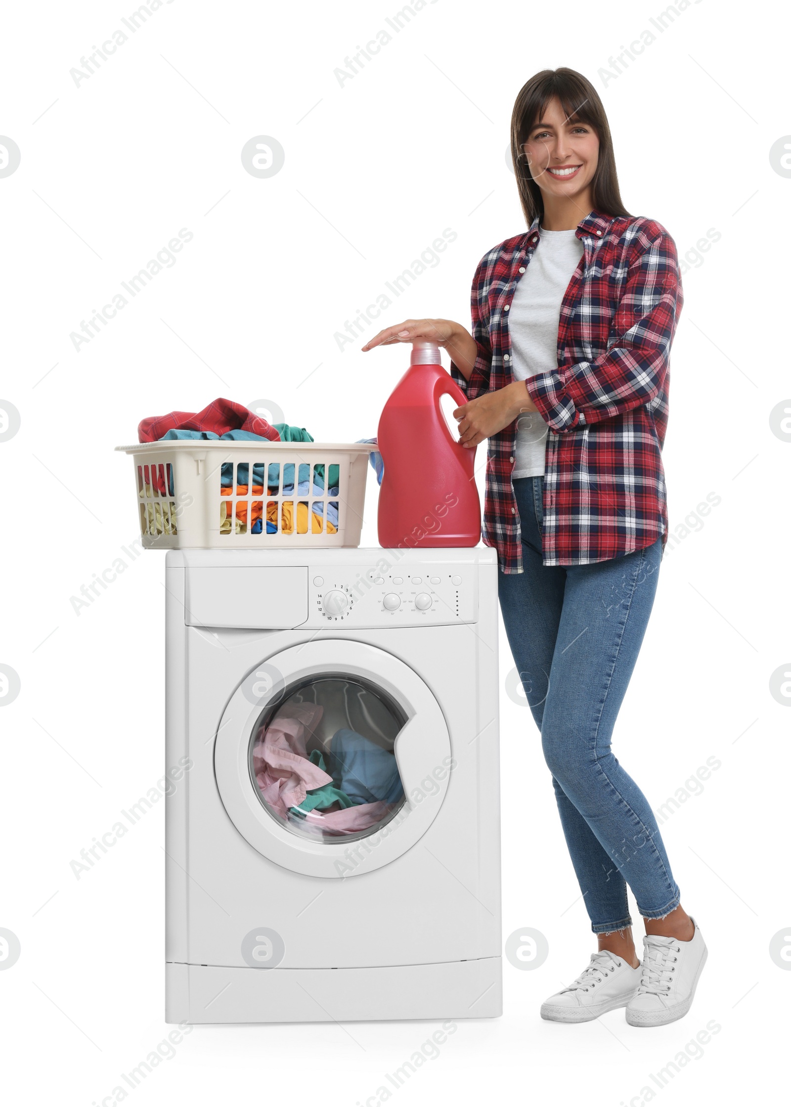 Photo of Beautiful woman with detergent and laundry basket on washing machine against white background