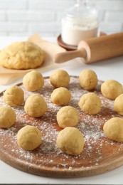 Photo of Shortcrust pastry. Raw dough balls on white table