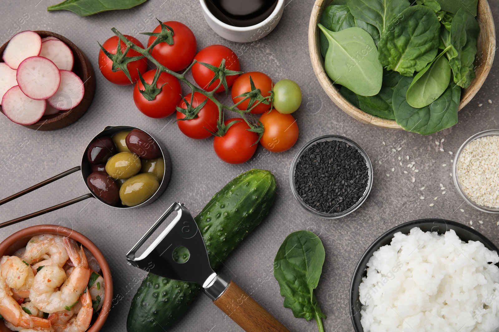 Photo of Ingredients for poke bowl on grey table, flat lay