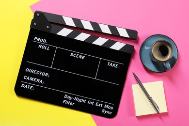 Photo of Movie clapper, coffee, paper notes and pen on color background, flat lay