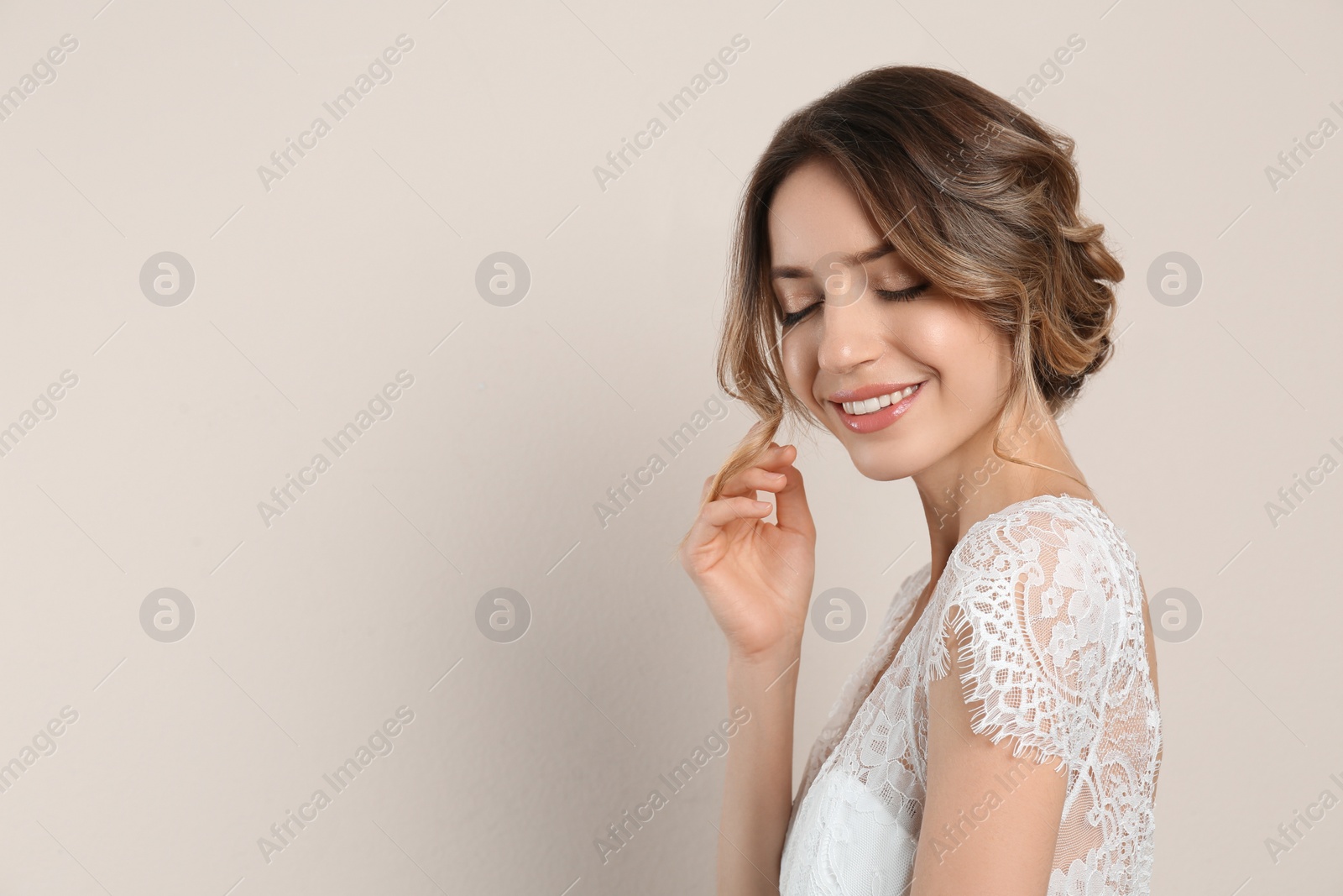 Photo of Young woman with beautiful hairstyle on beige background. Space for text