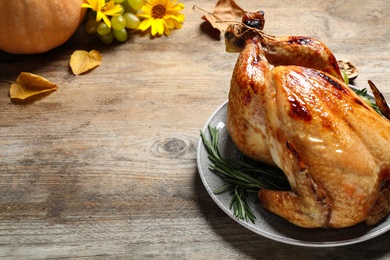 Photo of Delicious turkey on wooden background, space for text. Happy Thanksgiving day