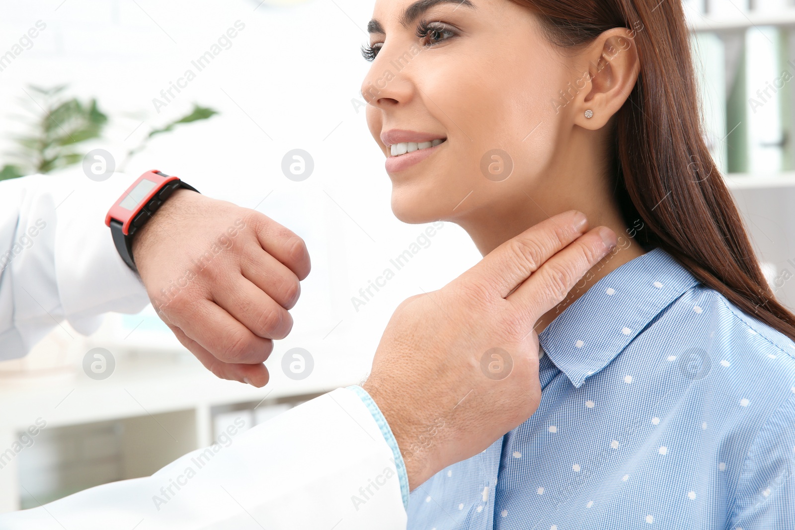 Photo of Doctor checking young woman's pulse with fingers in hospital