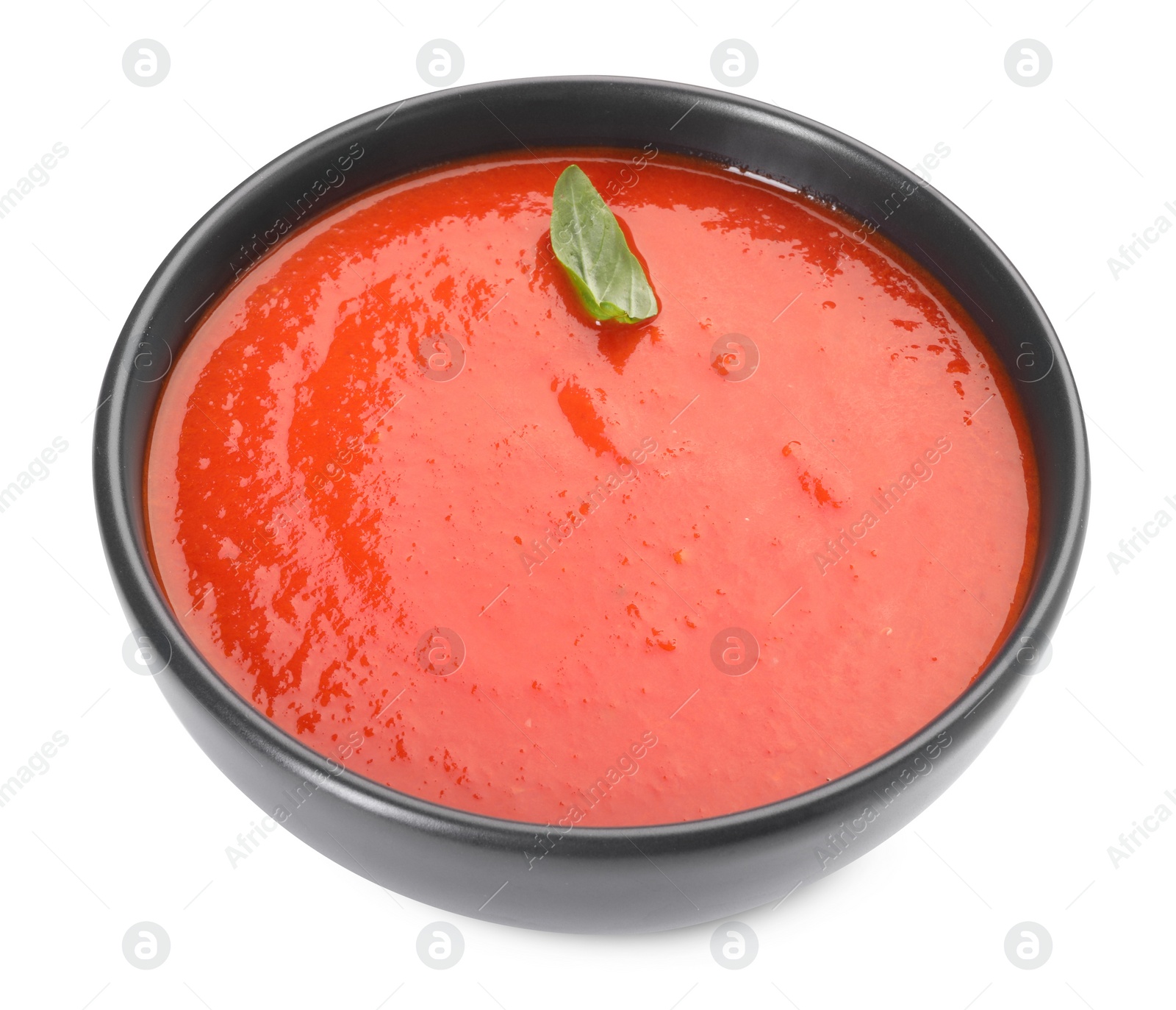 Photo of Delicious tomato cream soup in bowl isolated on white